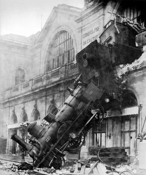 Train accident at French station, engine hanging out of building, late 19th century.