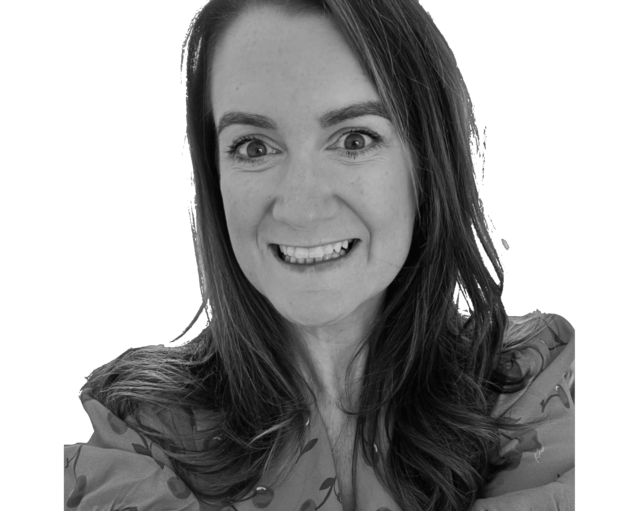 Smiling woman with long hair wearing patterned blouse, black and white portrait.