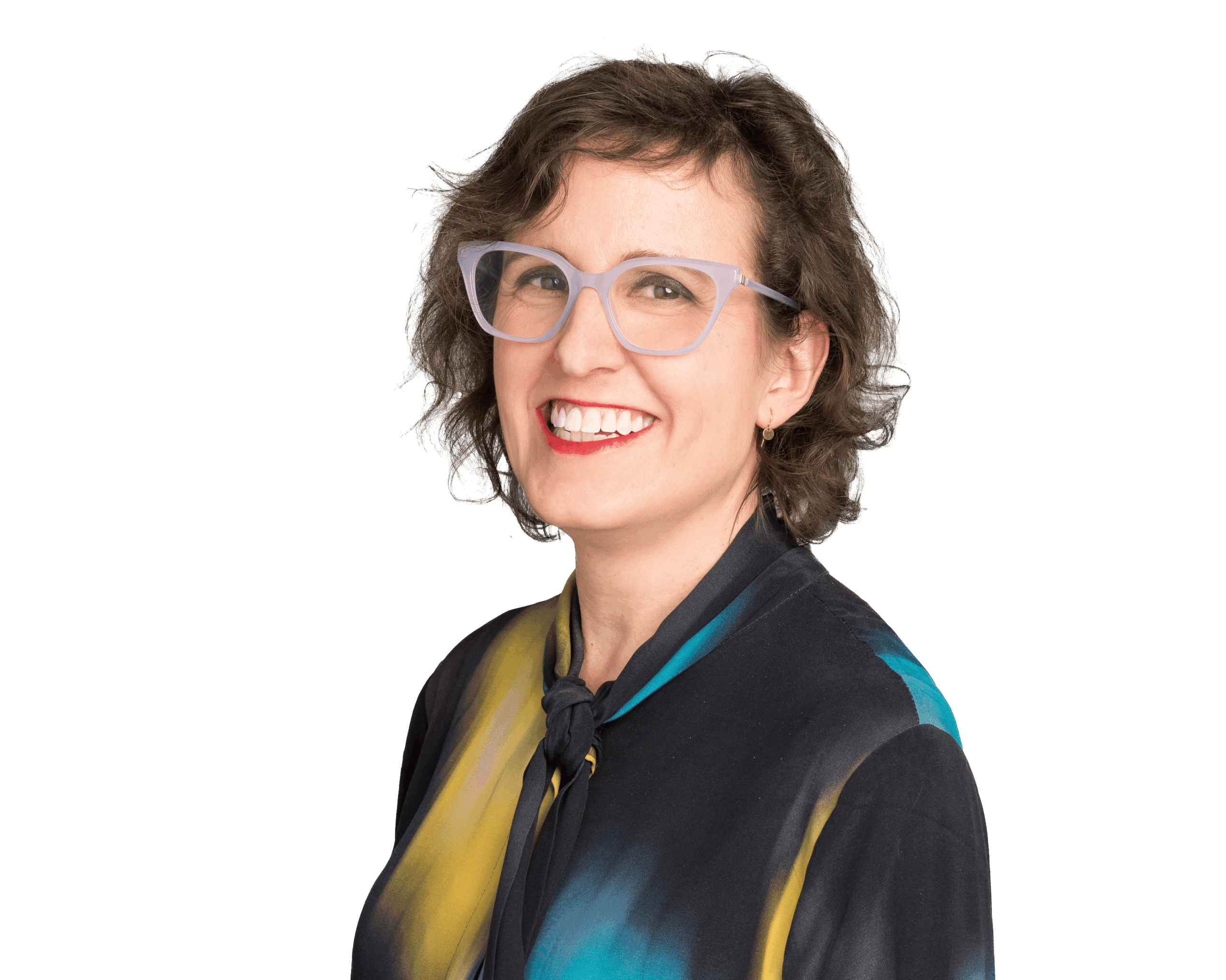 Portrait of a smiling woman with glasses in colourful clothing.